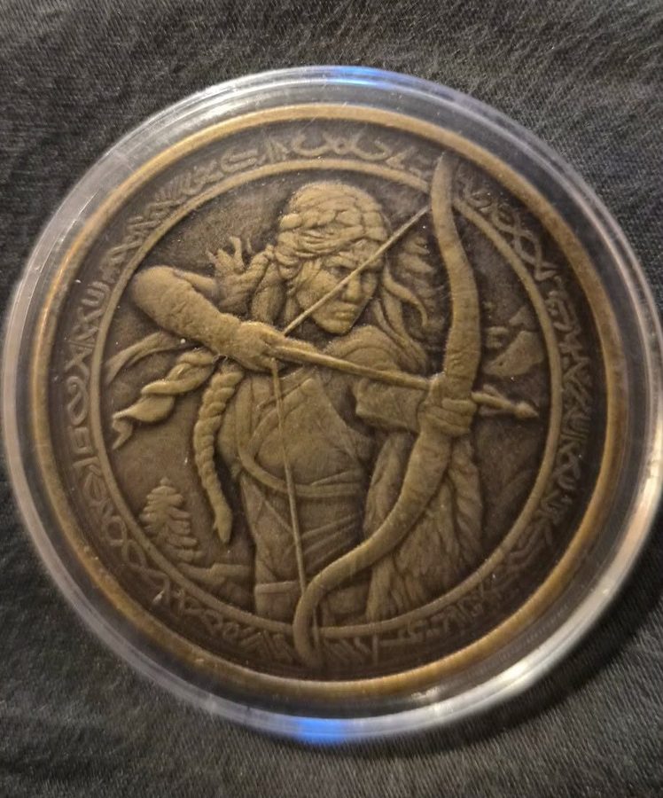 Brass medallion engraved with an archer drawing a bow