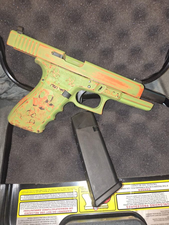 Glock finished in distressed green and orange Cerakote