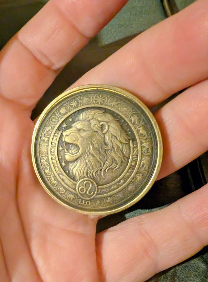 Brass medallion engraved with a Leo lion and zodiac border